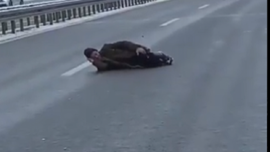 muškarac leži na autoputu